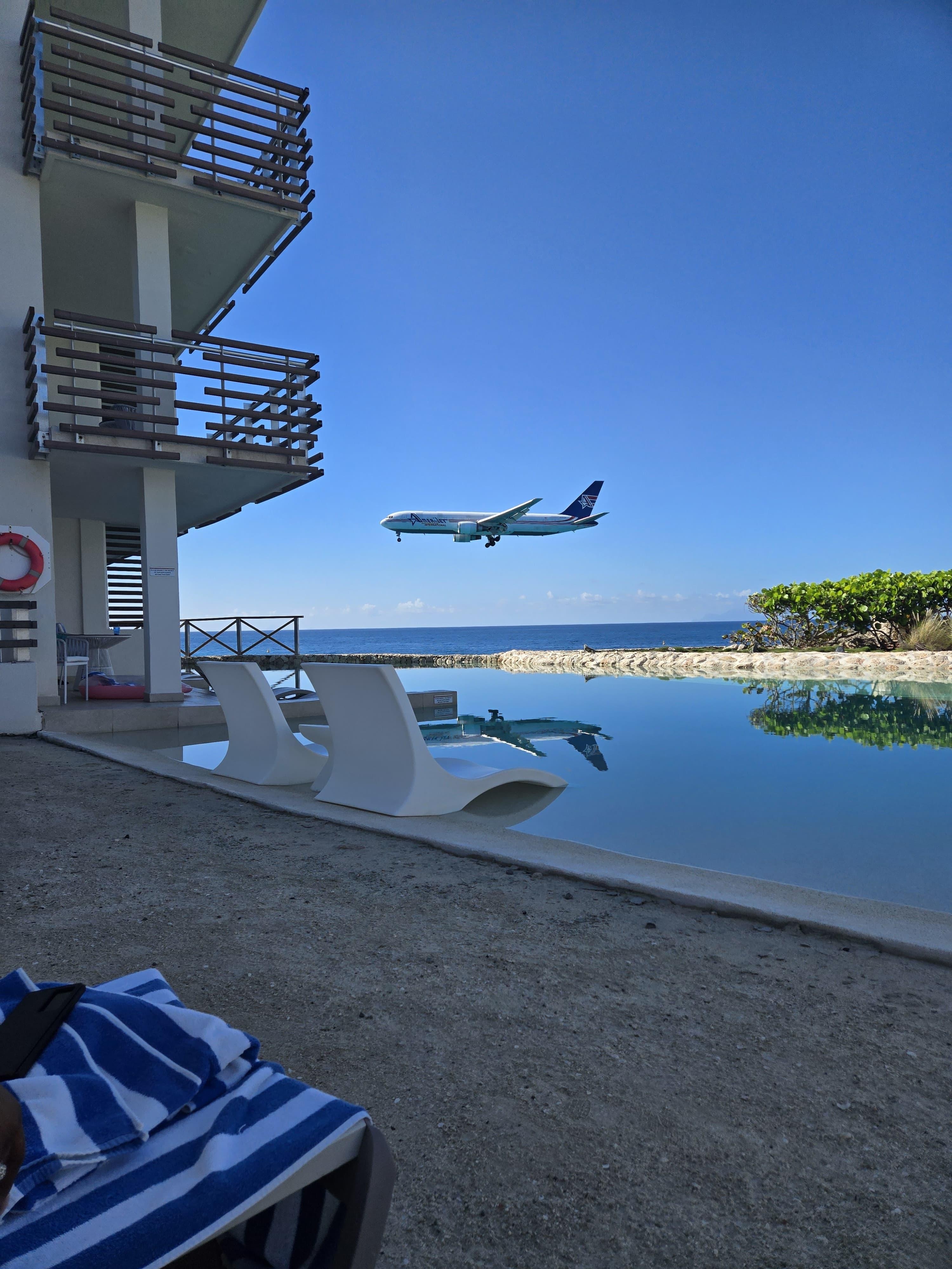 Edge pool with an iconic shot of a plane flying over. 