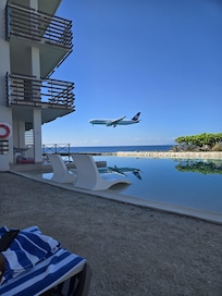 Edge pool with an iconic shot of a plane flying over.