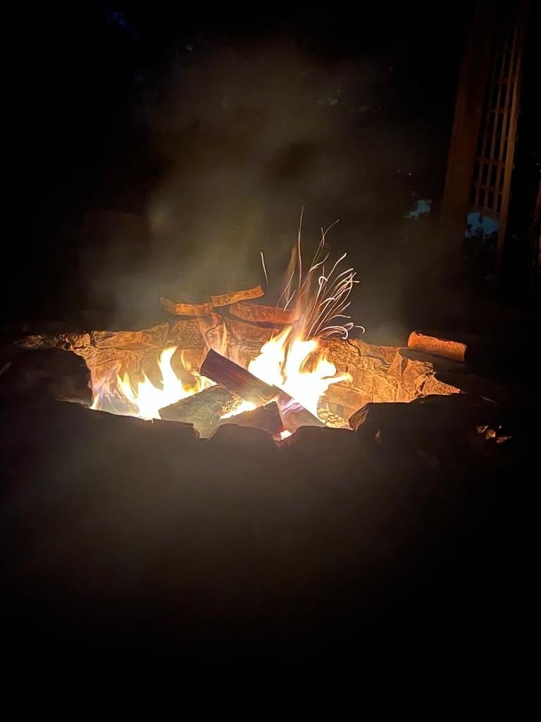 Excellent fire pit area with comfortable seating and firewood provided.