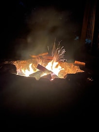 Excellent fire pit area with comfortable seating and firewood provided.