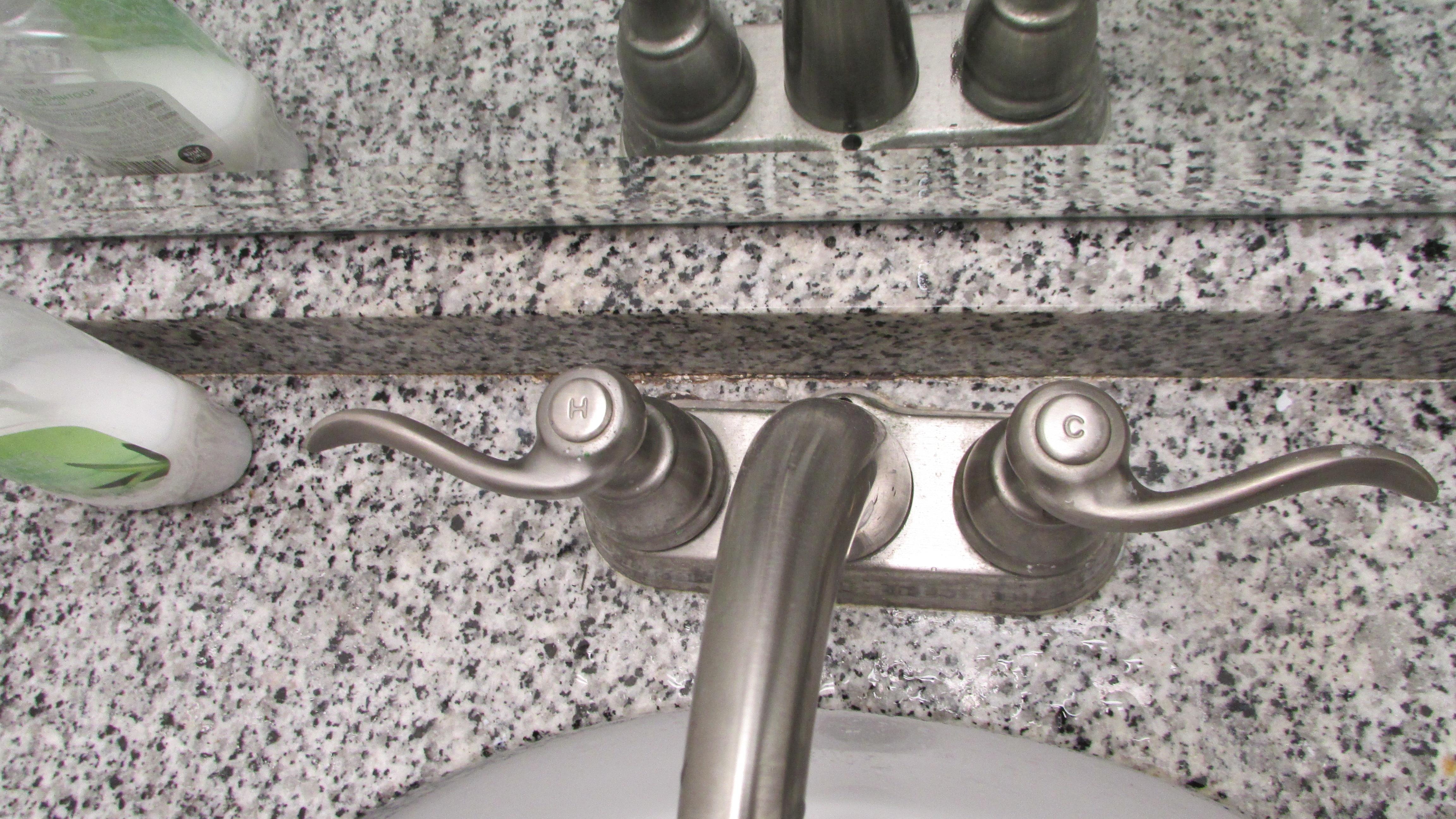 Dirt behind bath fawcet