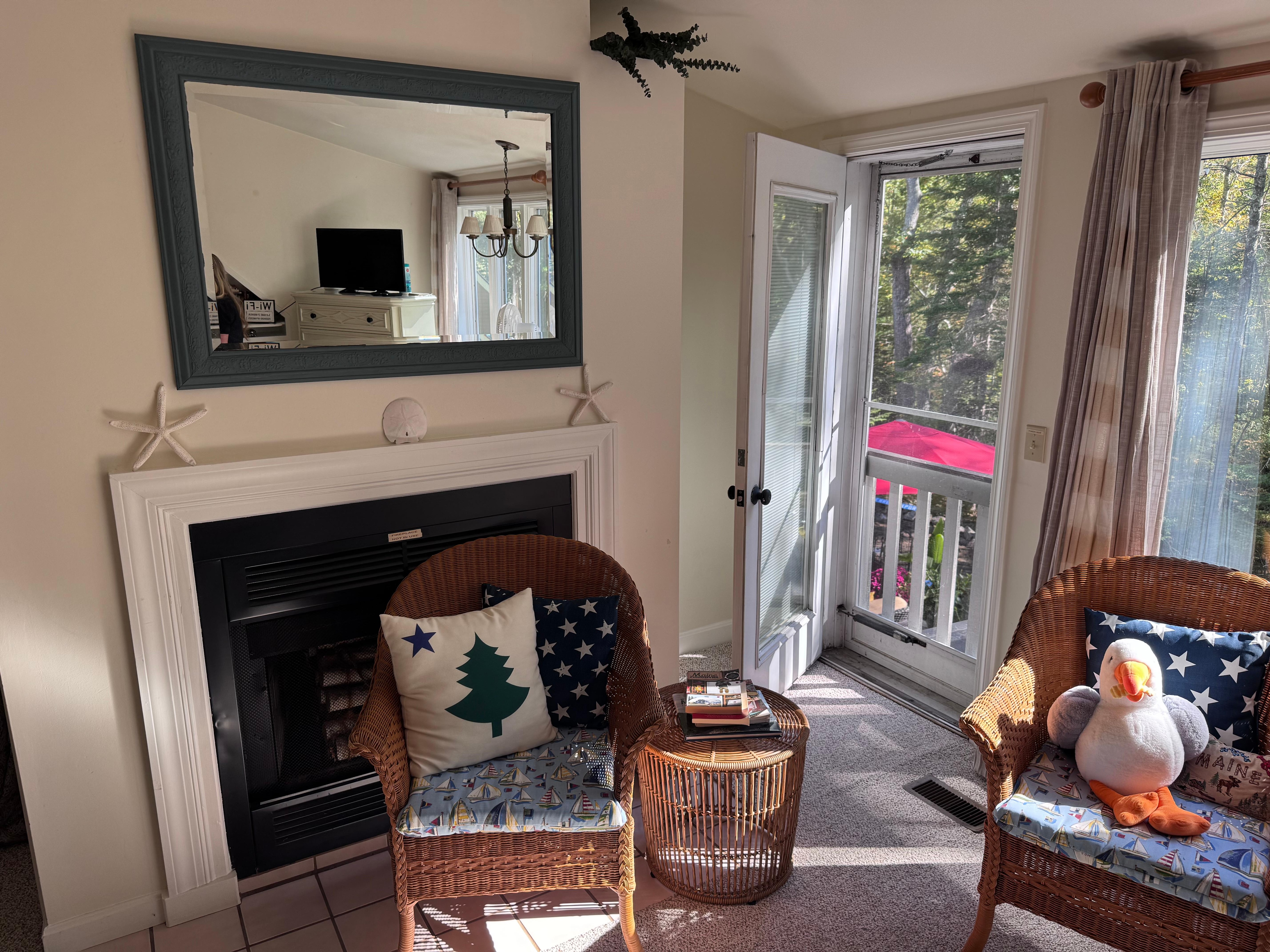 Nice sitting area with a door that opens overlooking the back patio. 