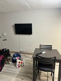 The television with electric cord plufgged in across the room