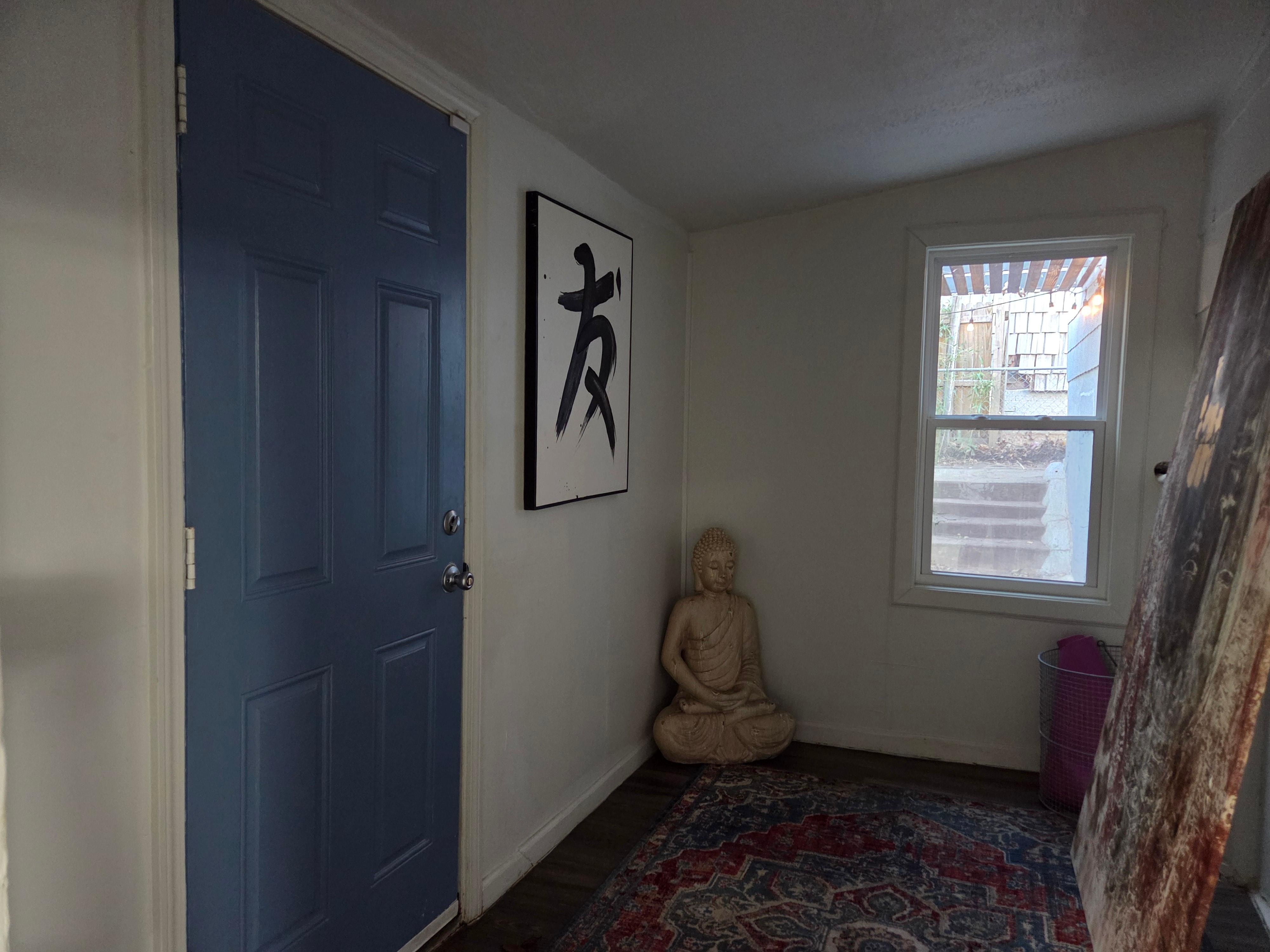 Exterior door to back yard with uncovered window.