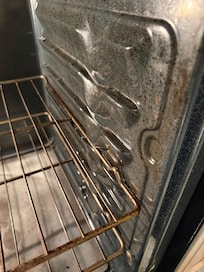 Oven is very dirty. Also dirty used cookie sheets in bottom drawer