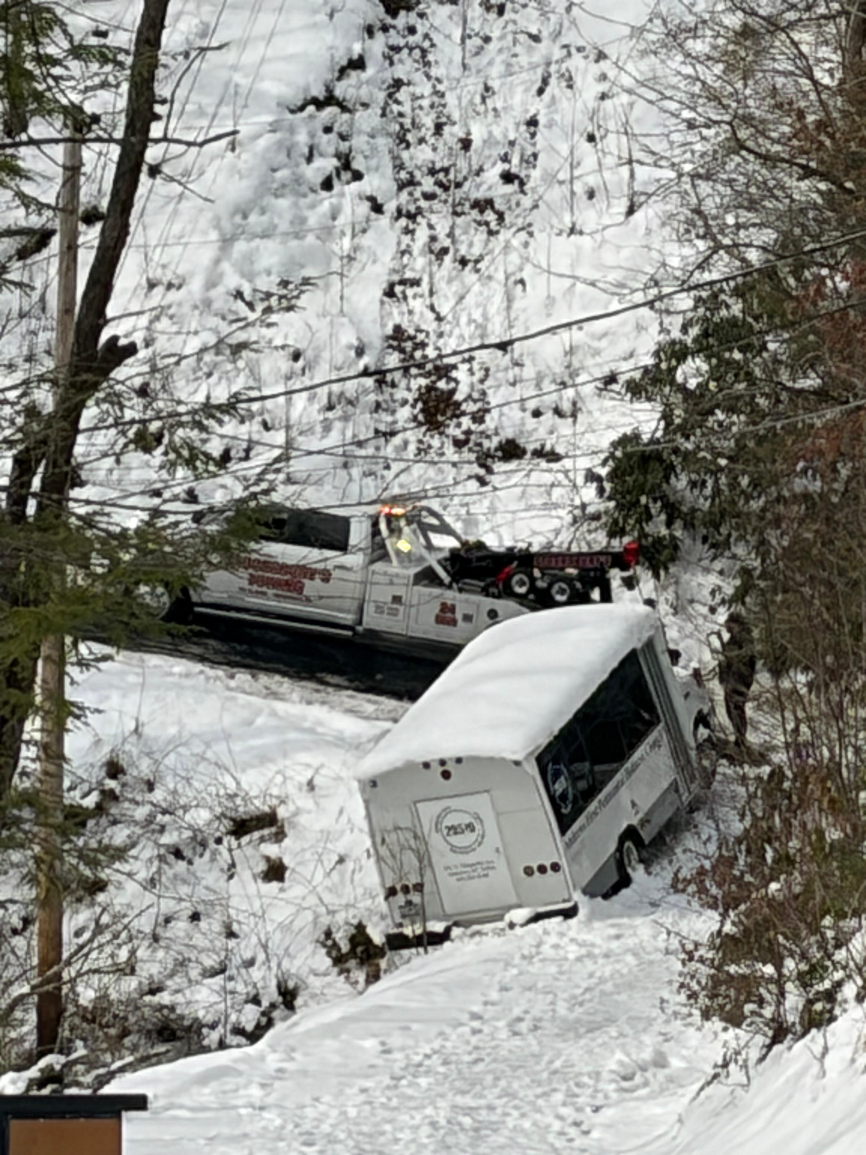 The bus stopped by a rock.  