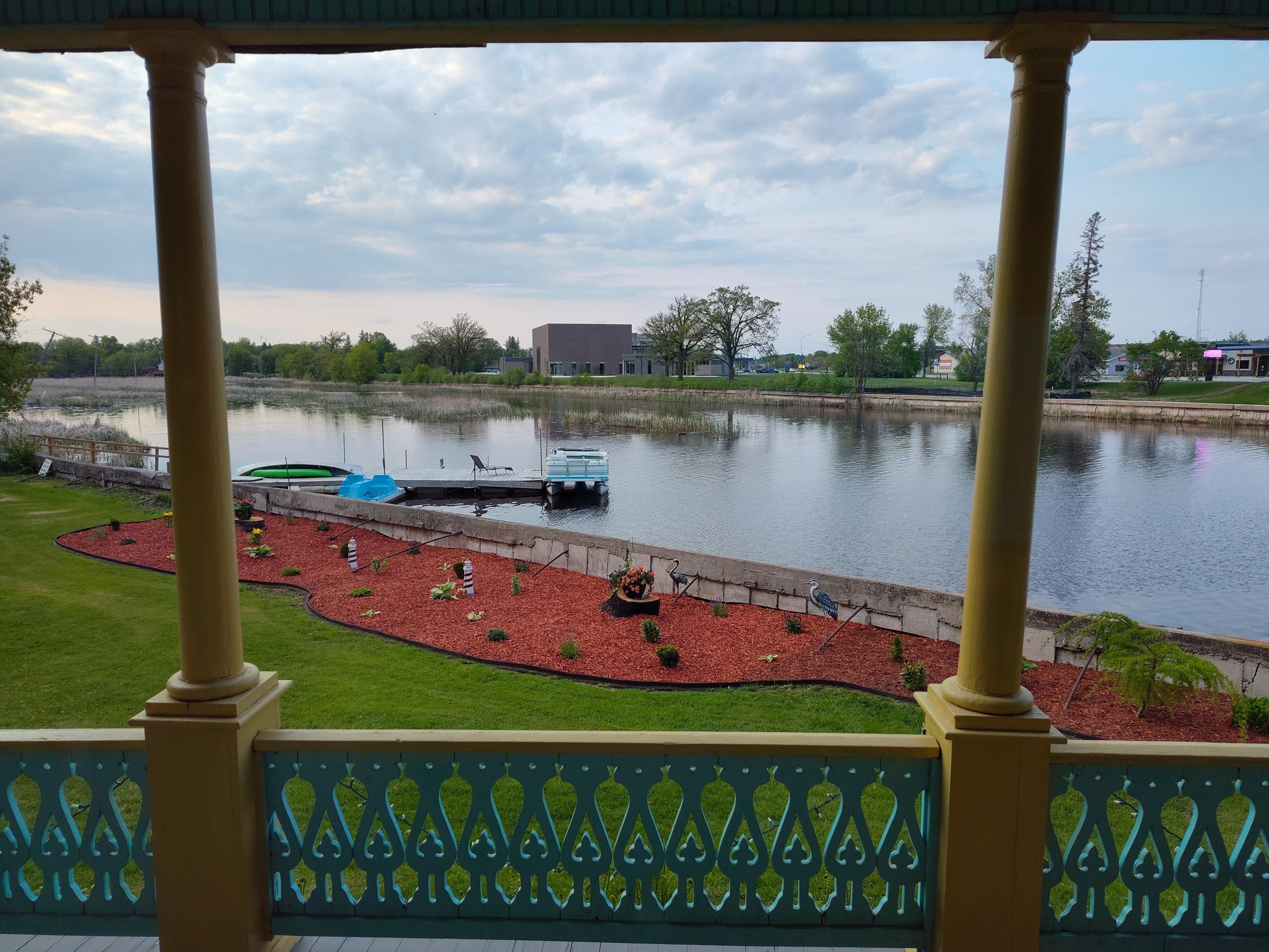 View of the river from the back door with a part view of the back deck railing.