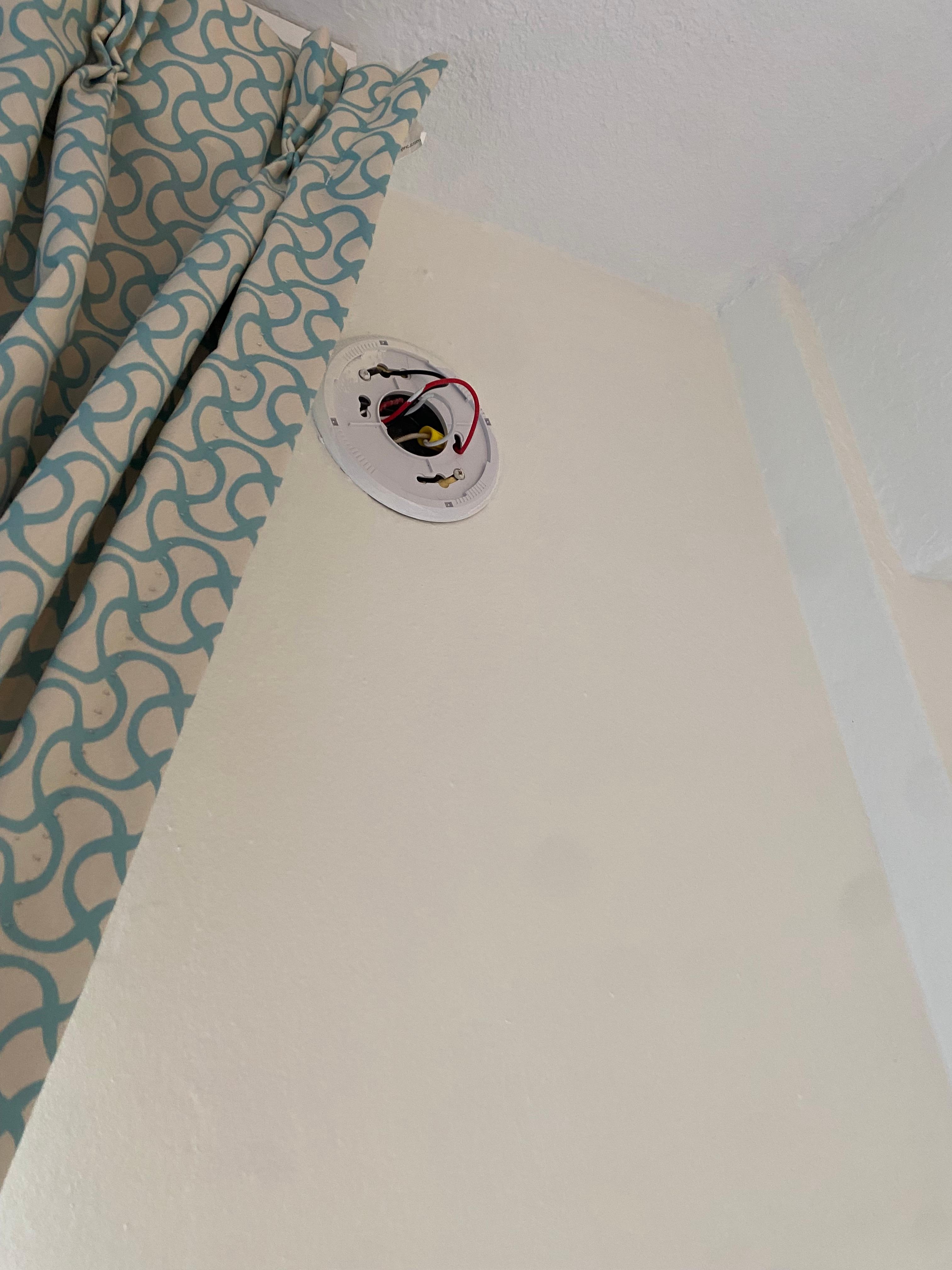 Wires hanging from wall where the smoke detector should have been.