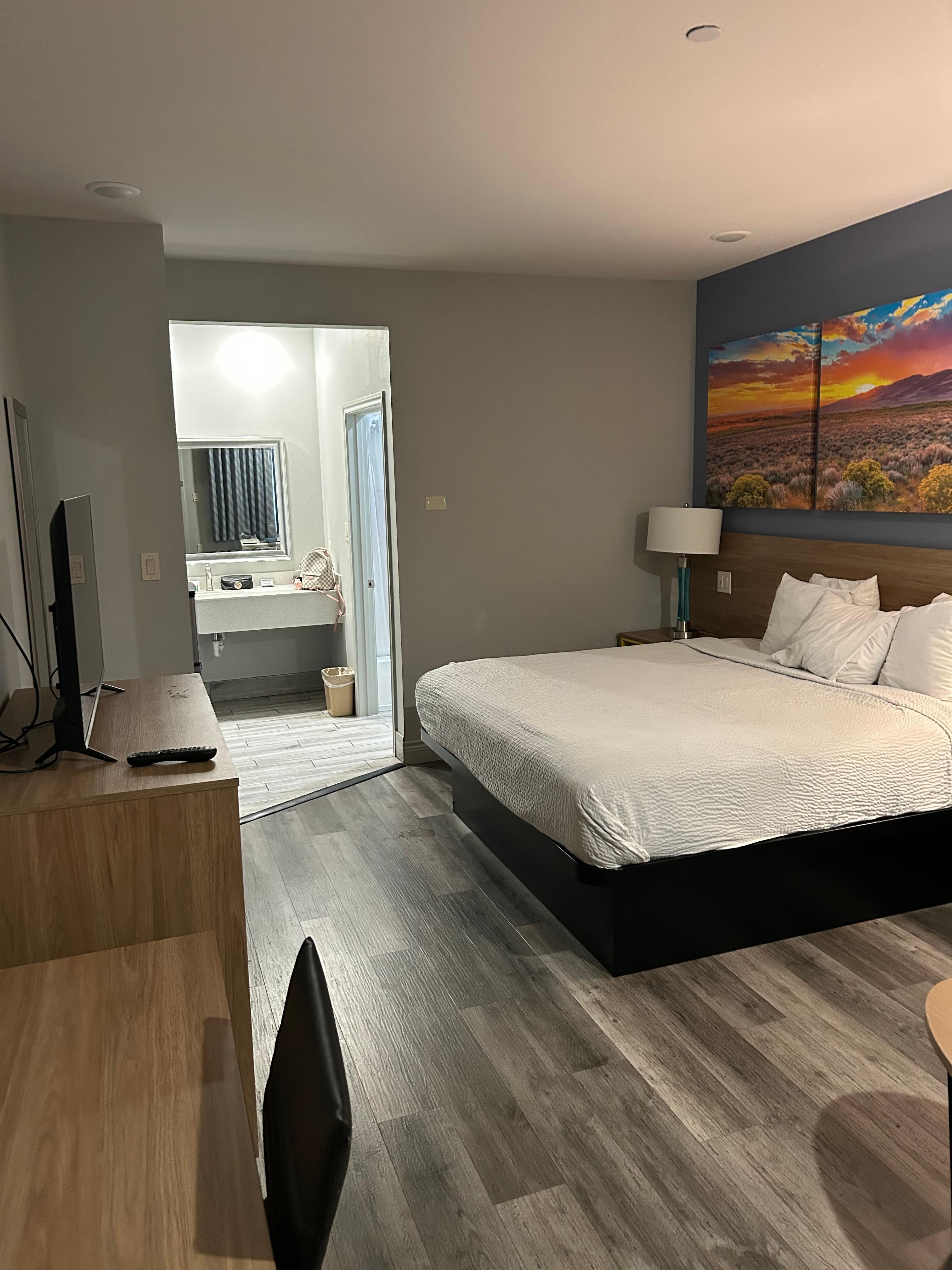 The king size bed with Roku TV and a desk