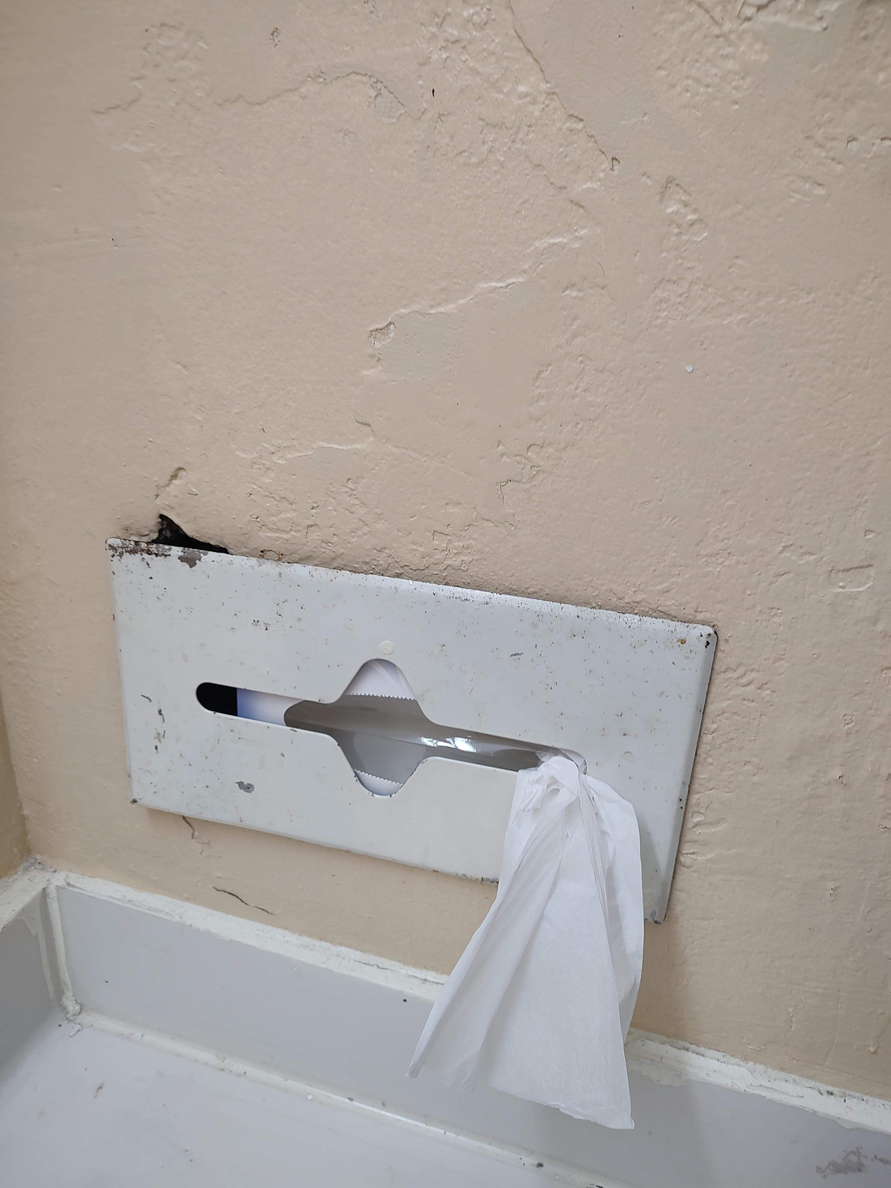 The tissue holder was falling off the wall