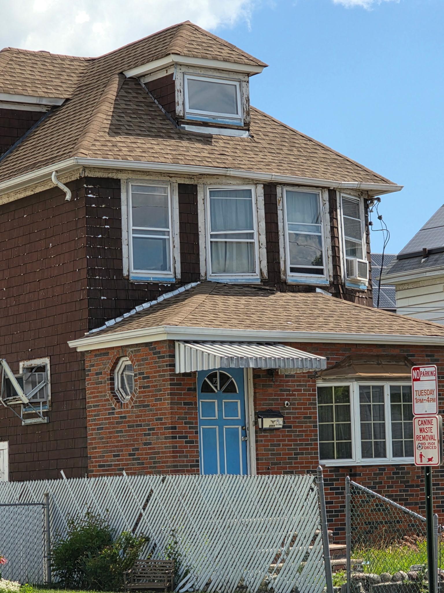 Poorly kept house across the street that shows the rundown neighborhood 