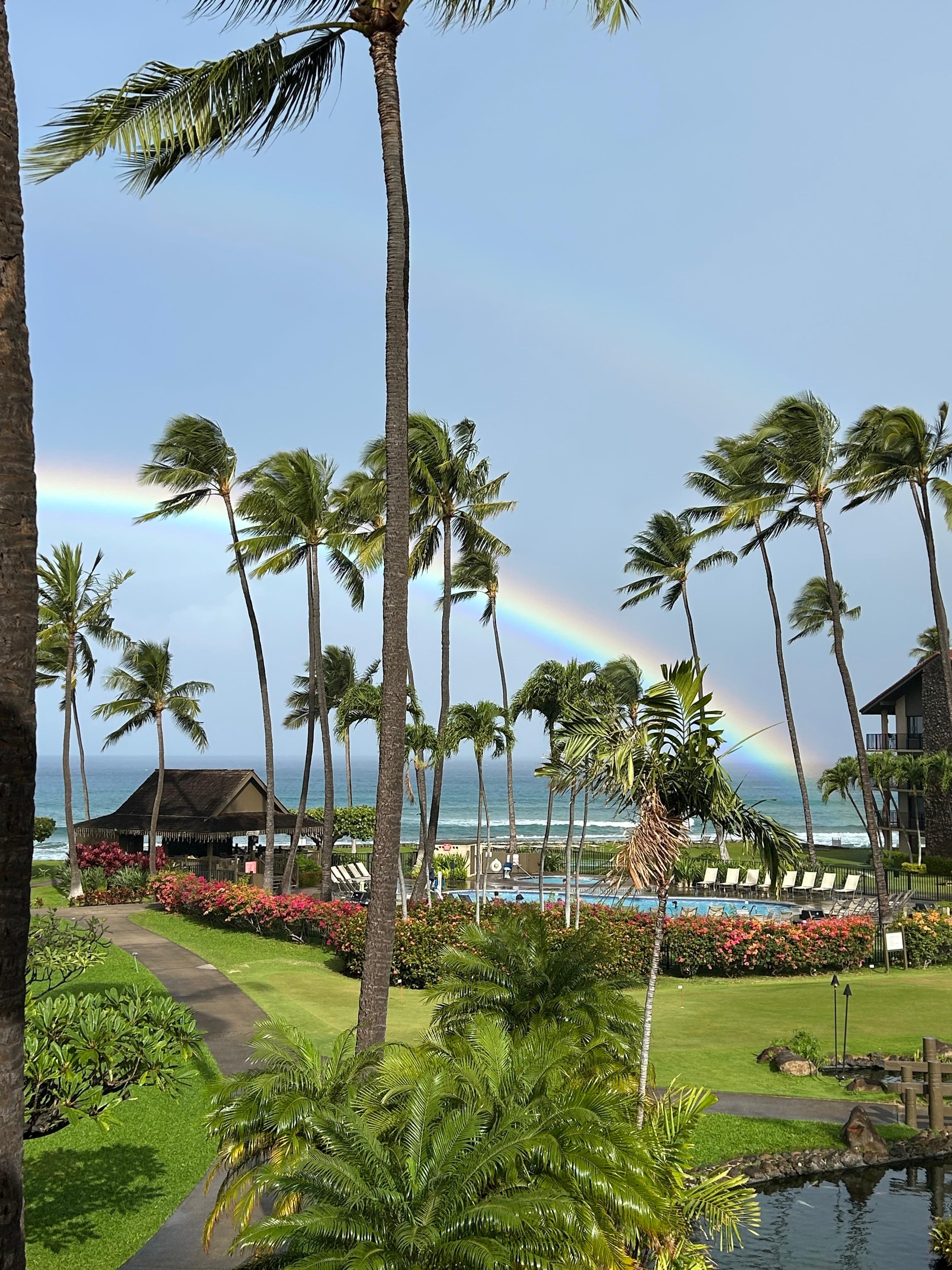 View from balcony with a rainbow over the ocean. 