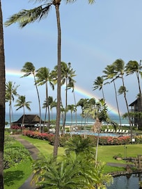 View from balcony with a rainbow over the ocean.
