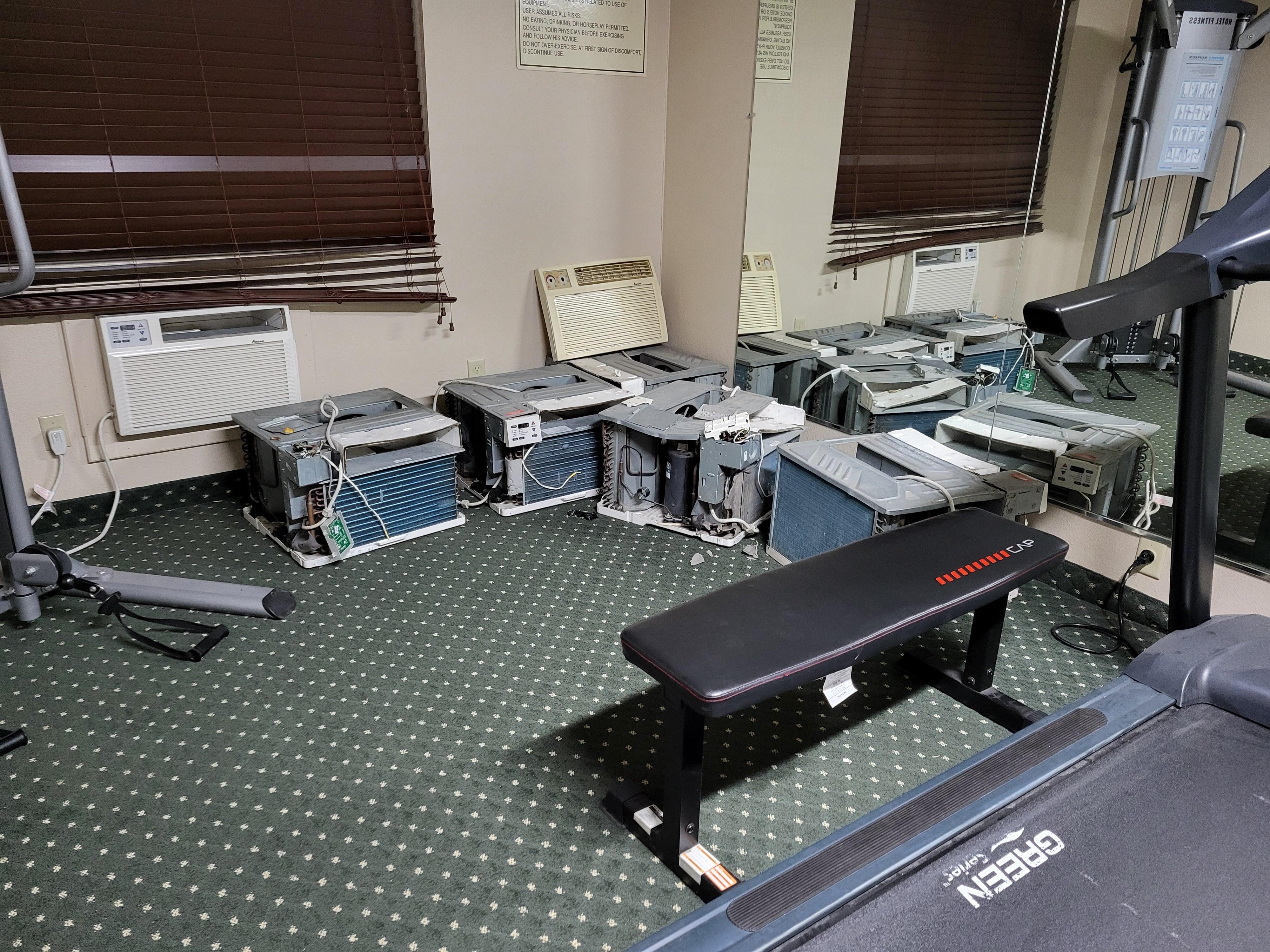 Fitness room with broken AC units on the floor - unsafe.