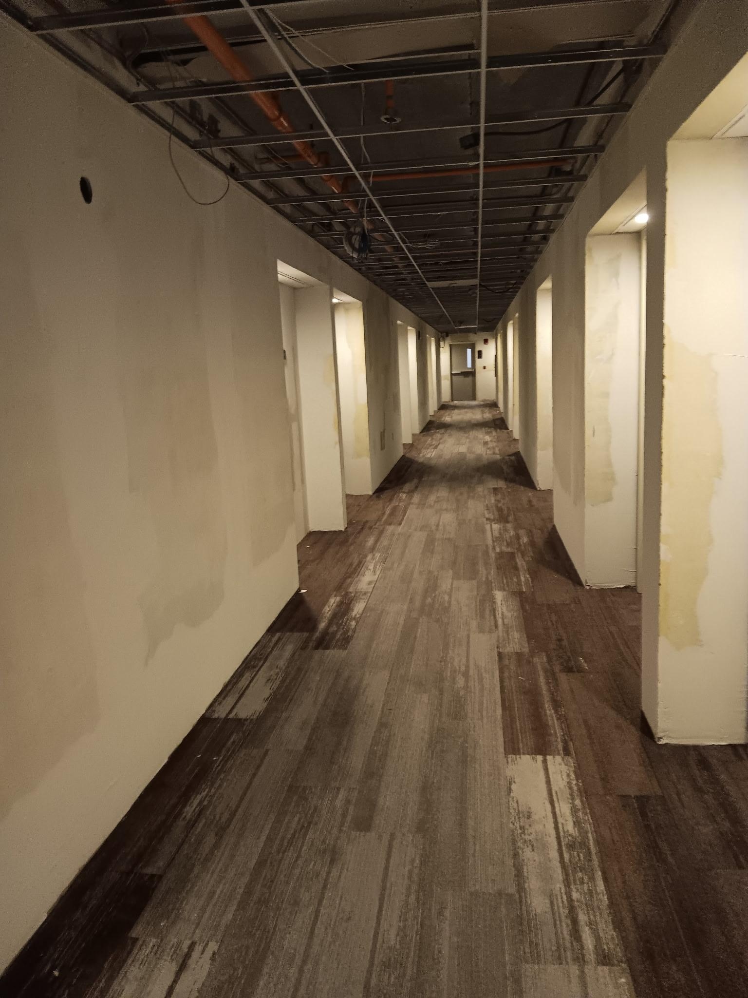 Hallway with wires hanging down under construction,  lights hanging down. Very bad and dangerous 