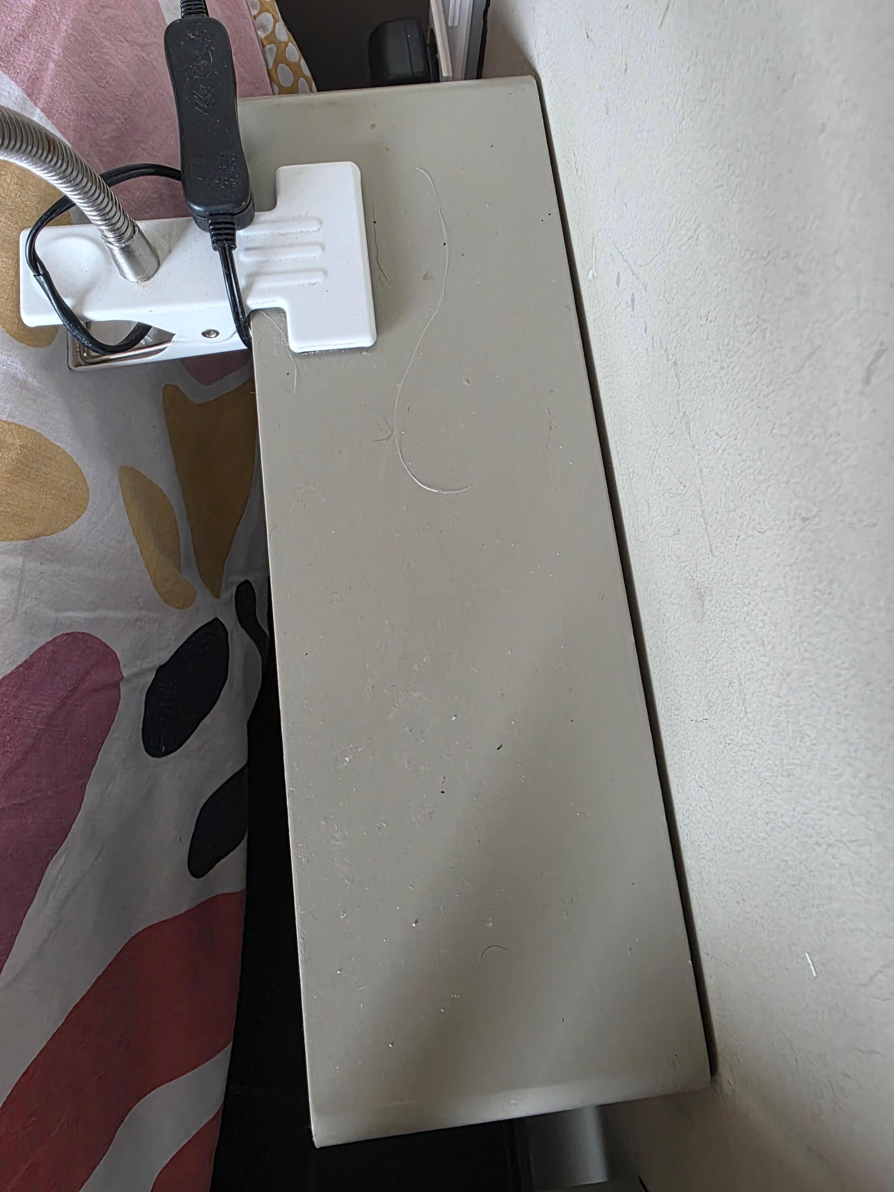 Hair and dust on bedside table in upstairs bedroom