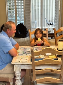 Board games are in the living room so Gpa and Bex are playing beach monopoly