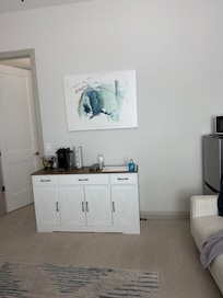 This is the kitchen area. It also has a nice refrigerator freezer microwave but no cooking. It does have a coffee pot no sugar single Colombian moved it a little bit, but it doesn’t. It looks like the back. I just moved it up against the line of the