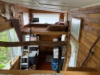 The view from the sleeping loft down into the kitchen and across to the loft for relaxing with a book or television.