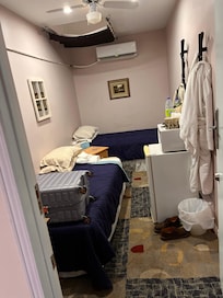 This is the room they call a deluxe accommodation note the blanket hanging over the broken skylight. The open pipe from the air conditioner over the bed. I’m lucky it didn’t leak on me. The room smelled, and there were cigarette burns in the blanket