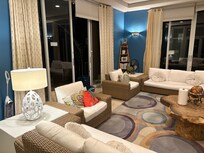 Beautiful sunroom living area with a gorgeous night view of city lights.7