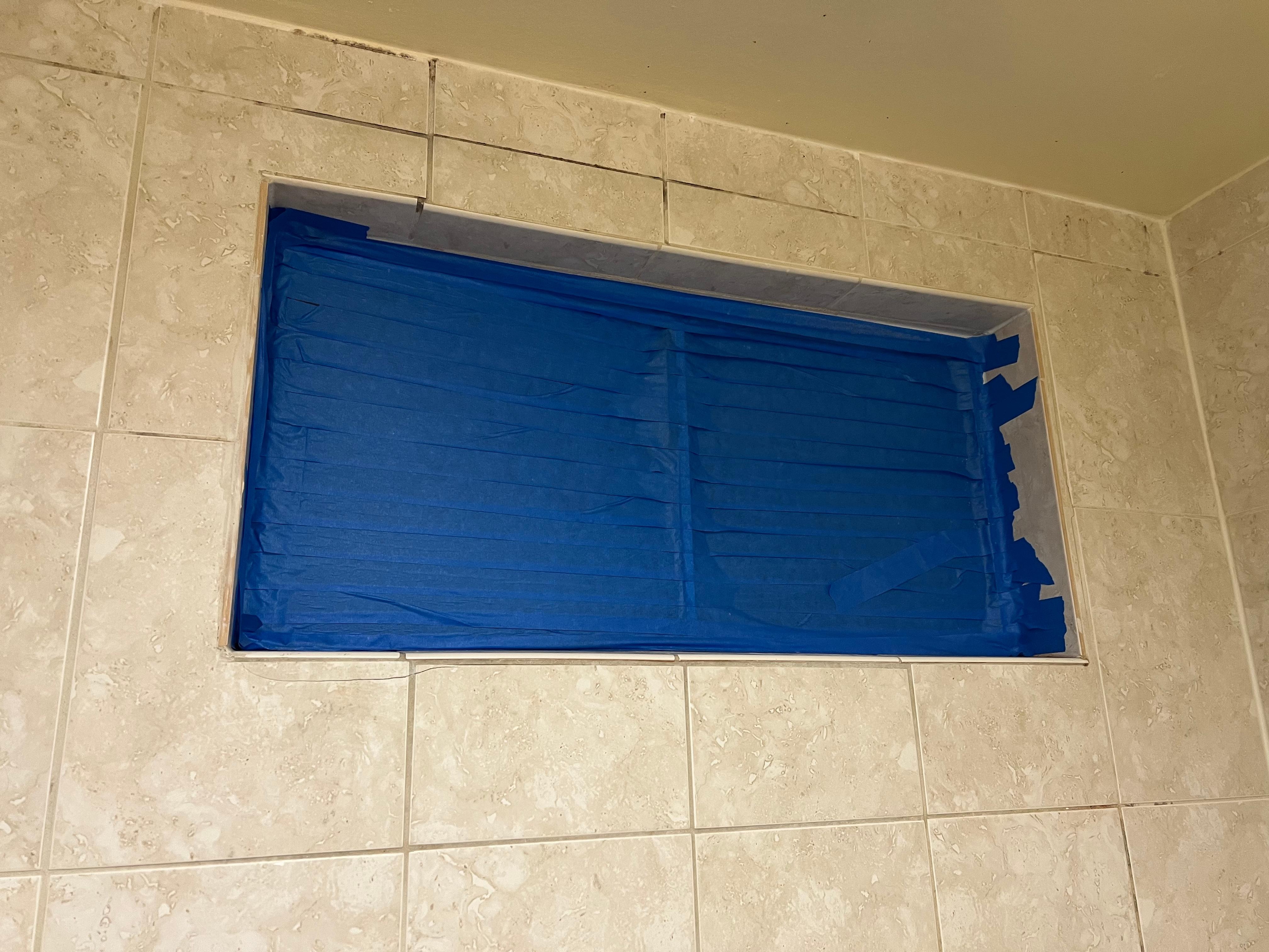 Taped up Bathroom Window (illegal to not have a fan or operable window in a bathroom)