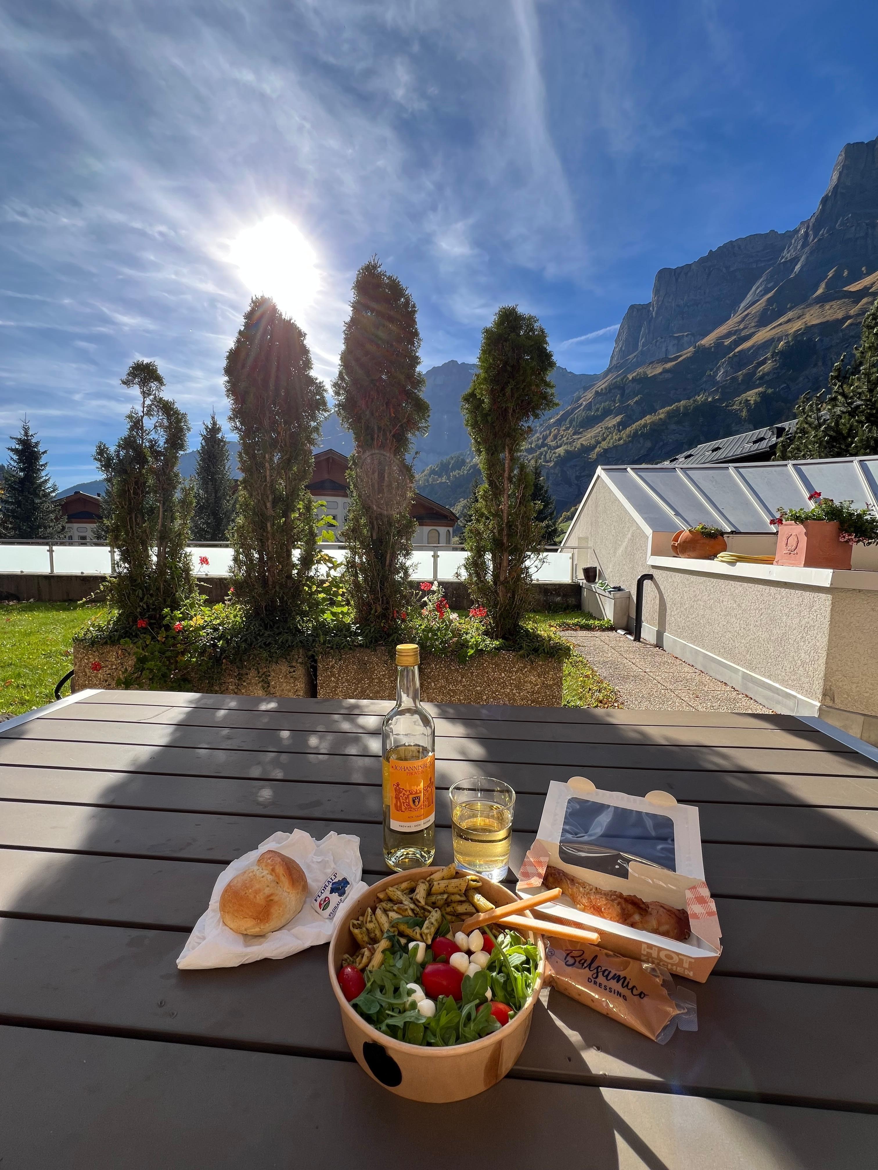 In front, picnic table lunch with mountain view