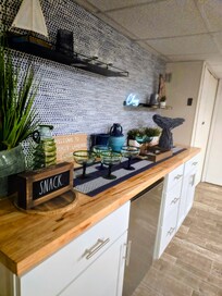 Lower level bar, refrigerator, and game area