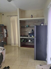 "SUITE WITH KITCHEN AND LAUNDRYZ" is a single room with a refrigerator and countertop with hotplate , next to the bed. There is no closet.
c