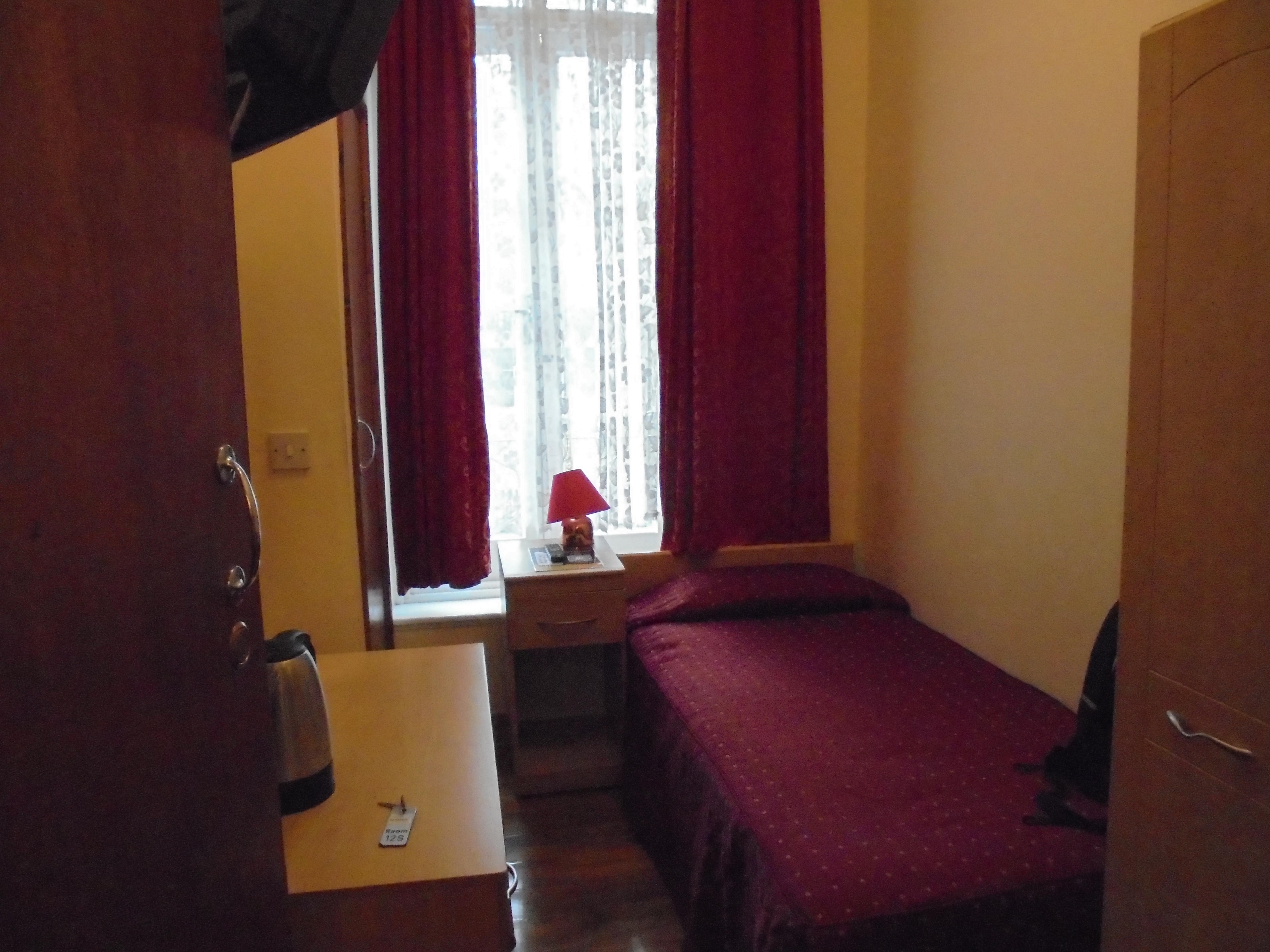 Room with view over Argyle Square, bedside lamp & bed.