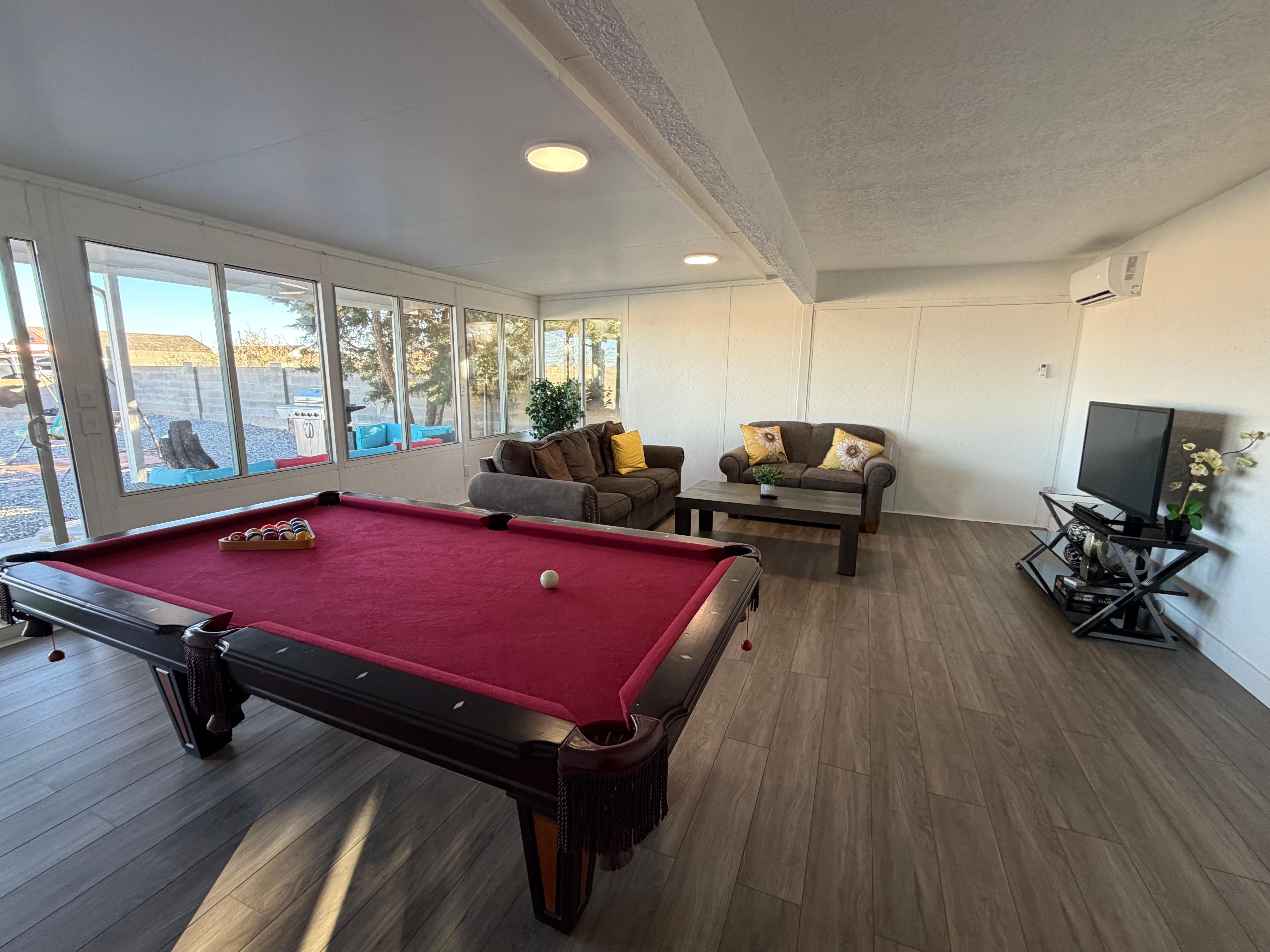 Family room with pool table and couches.