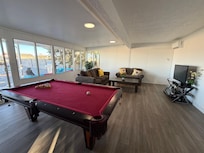 Family room with pool table and couches.