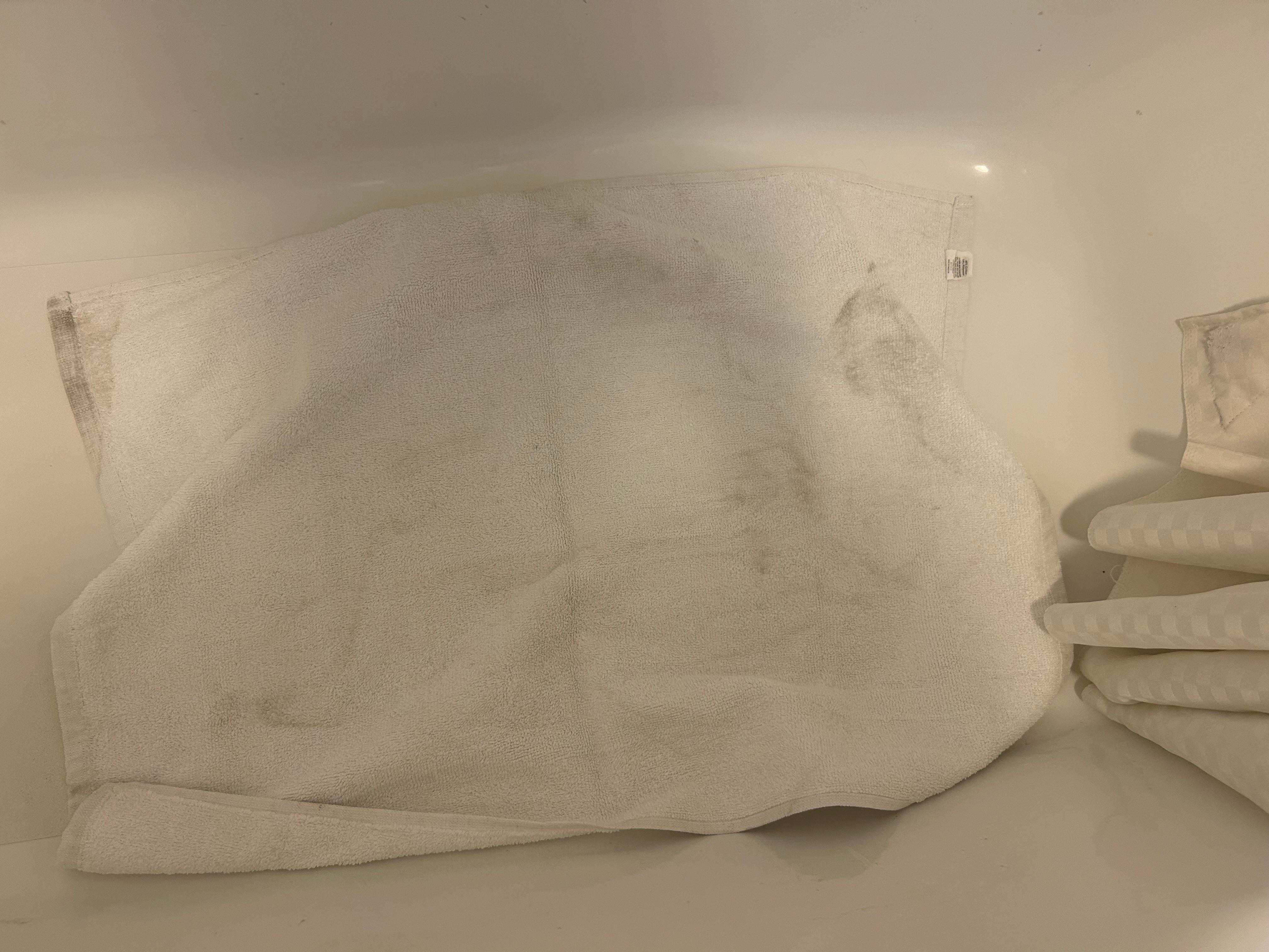 Dirty towel in bathroom tub