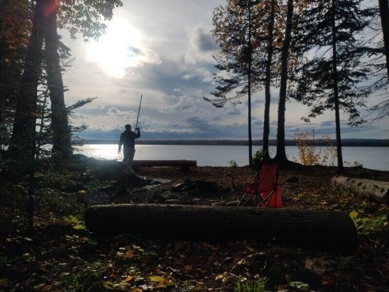 View of fire pit area w/ log benches looking NW. Solid jump-off spot for Huron Mtn adventuring. We spent a whole afternoon going to/from & climbing one east of Big Erick's bridge.