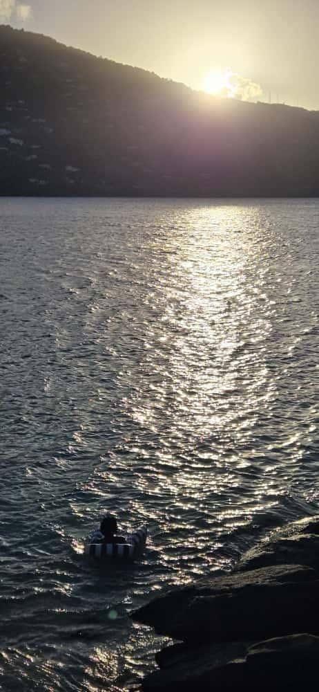 Enjoying the sunset in the bay using the inflatable hammock included with villa