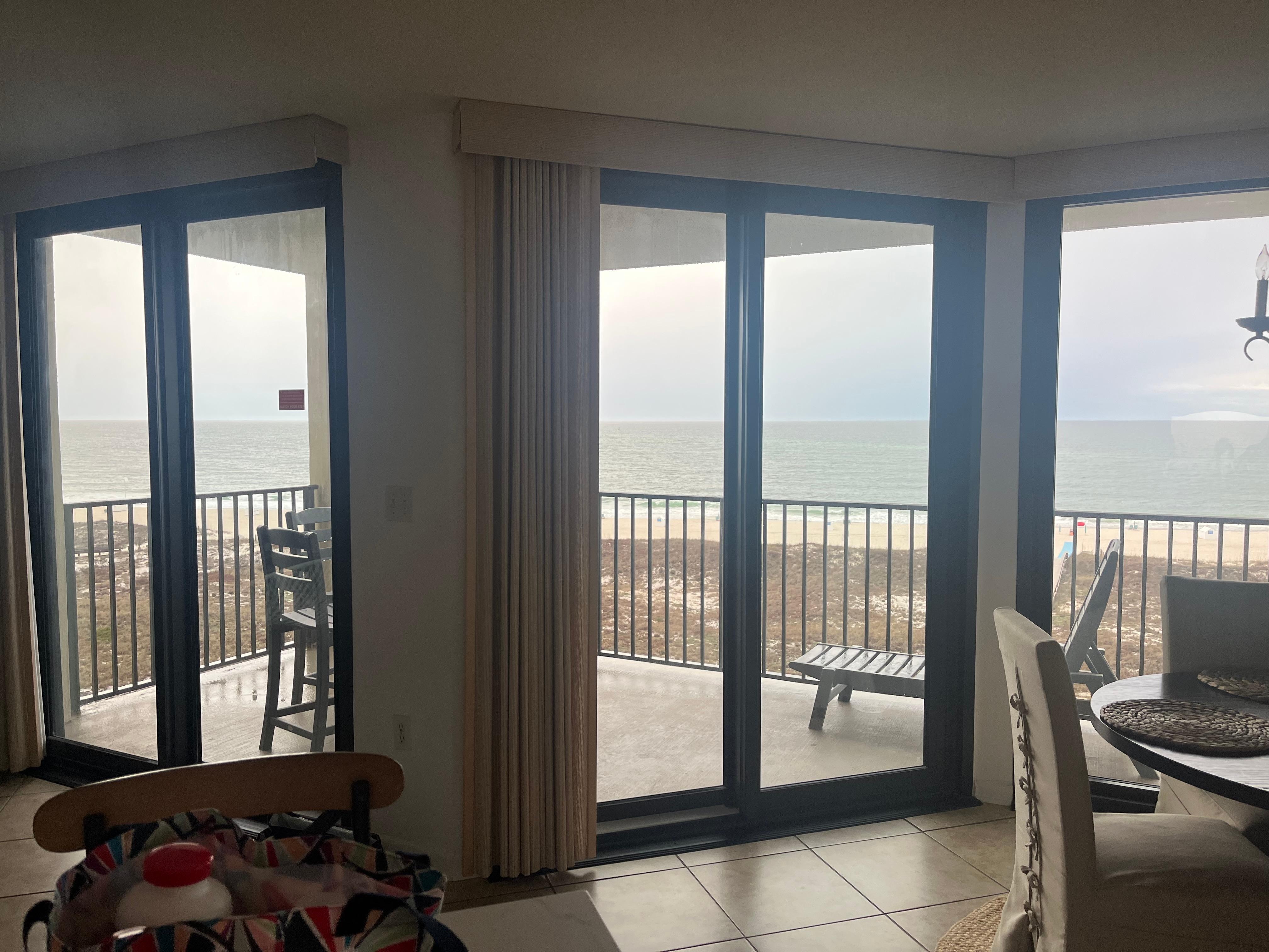 Standing in the living room looking out the glass doors.