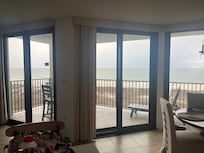 Standing in the living room looking out the glass doors.