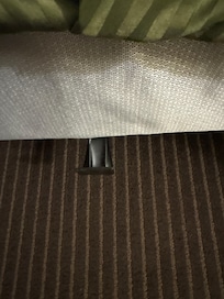 There was a bracket that came out the side of the bed and covered up by bed skirt