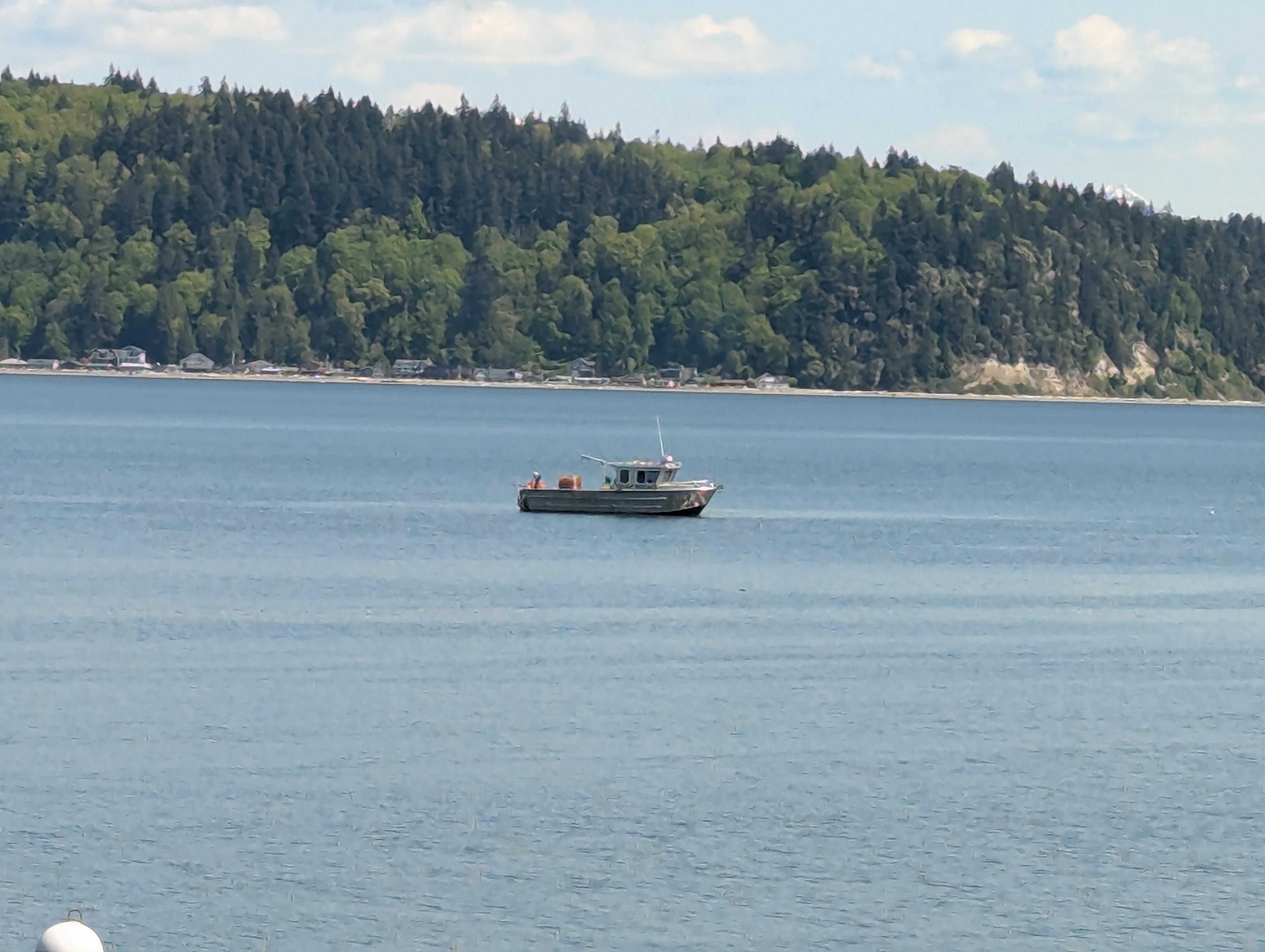 The girls got a kick out of the passing little fishing boat.