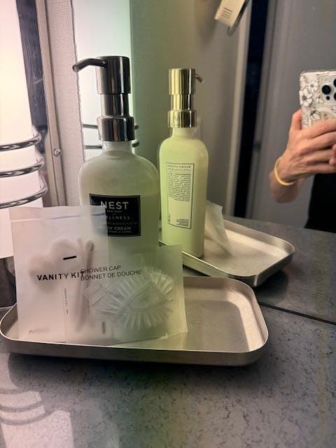 A half empty bottle of body ltion and a shower cap...not luxury toiletries.
