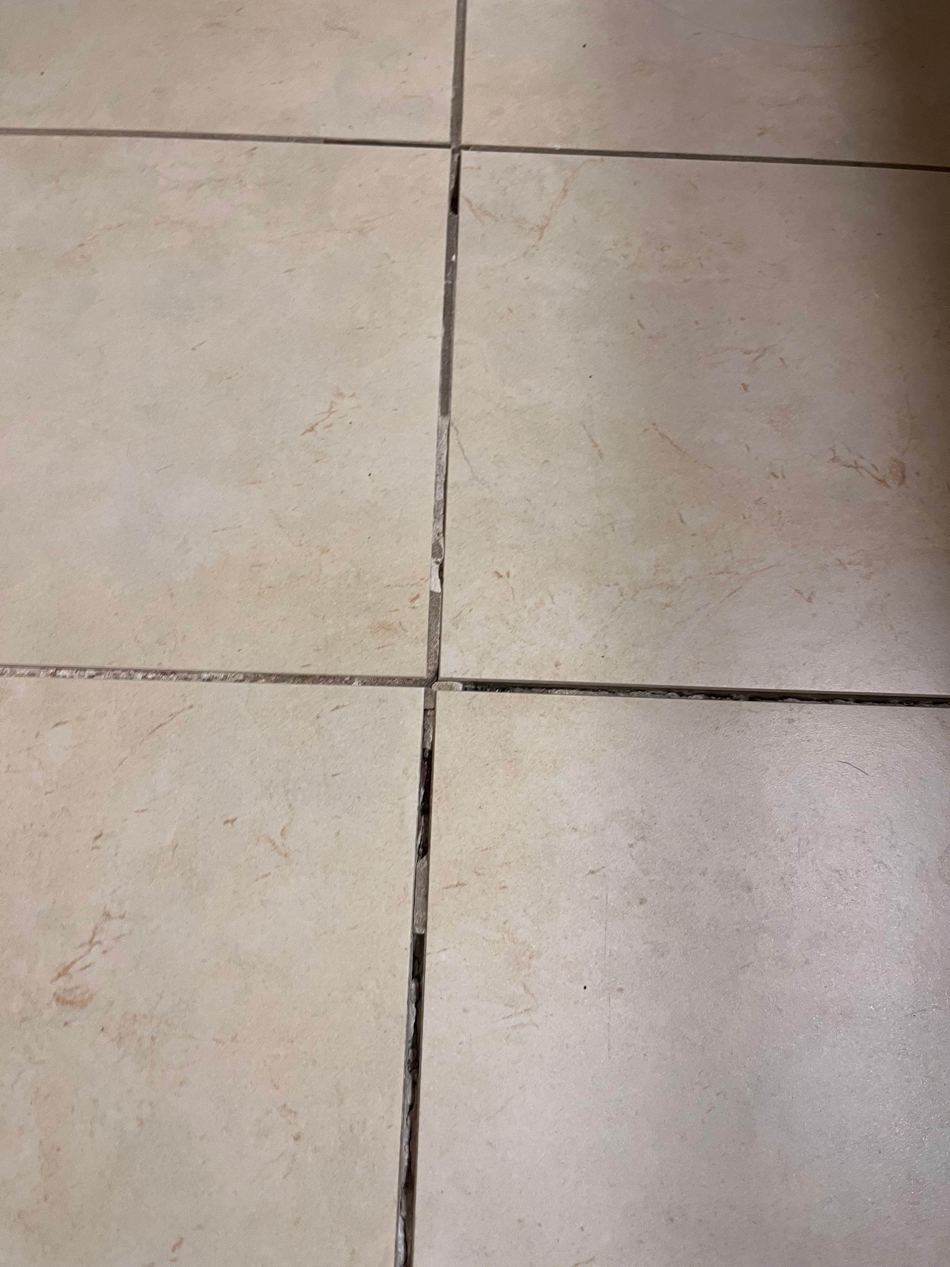 Missing grout, and the tiles moved. 