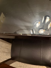 Dried peanut butter on edge of glass top table