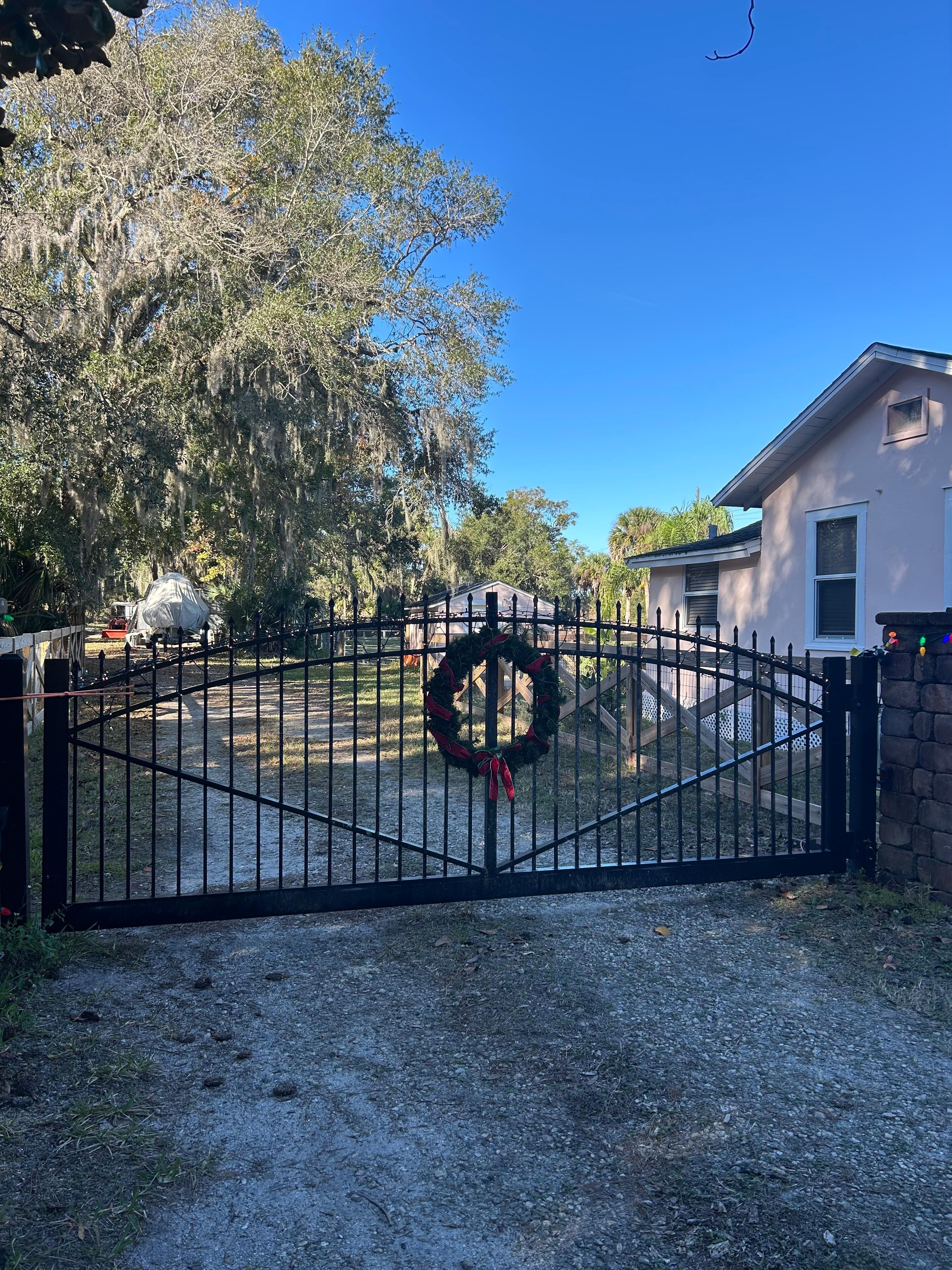The host decorated  the gate and fence for Christmas. 
