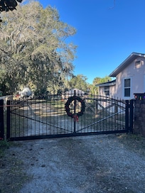 The host decorated the gate and fence for Christmas.