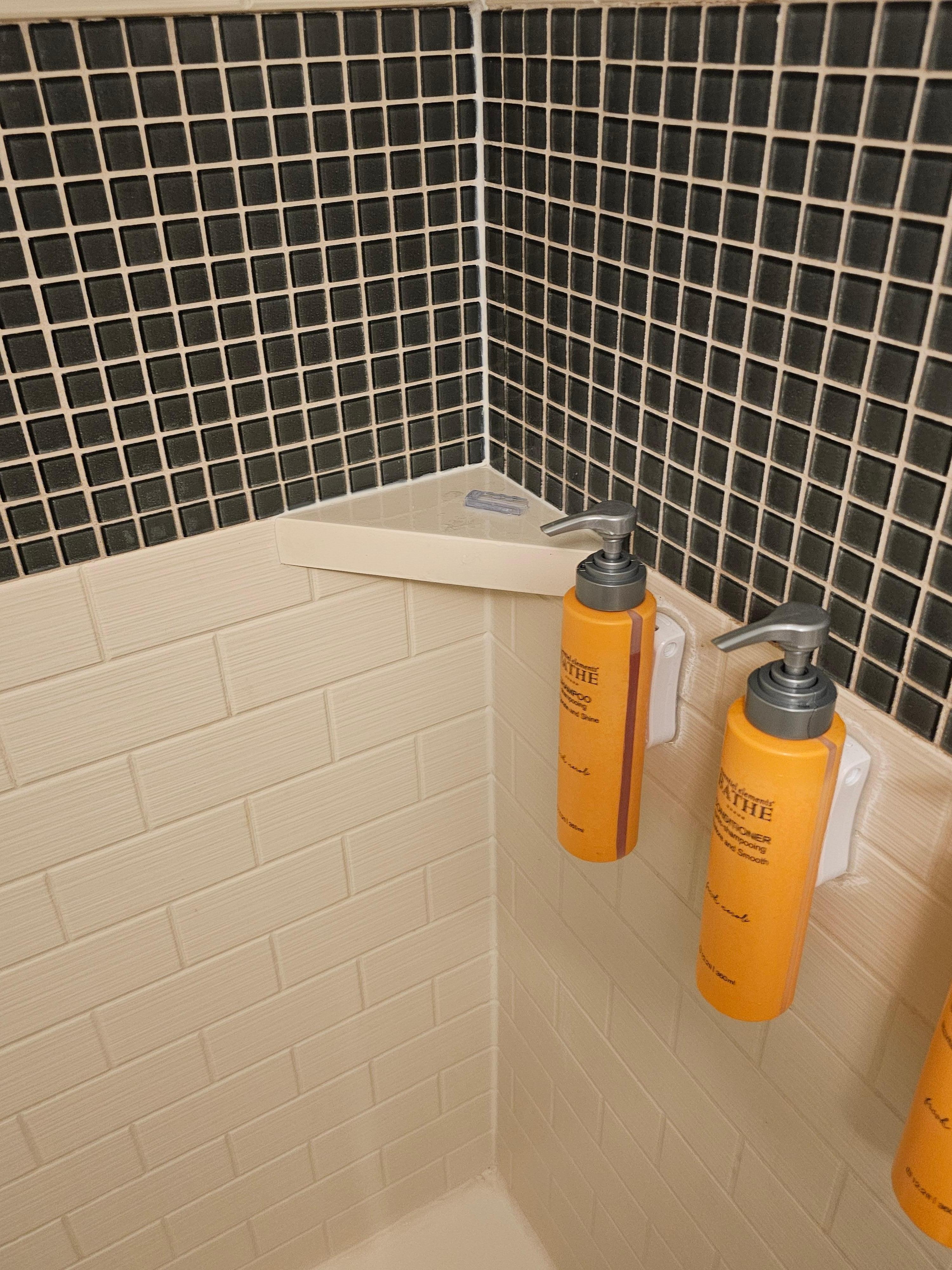 Razor guard left on the shower ledge from previous resident