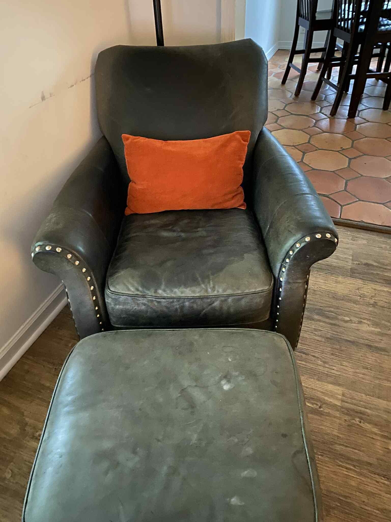 Living room chair showing a good amount of wear.