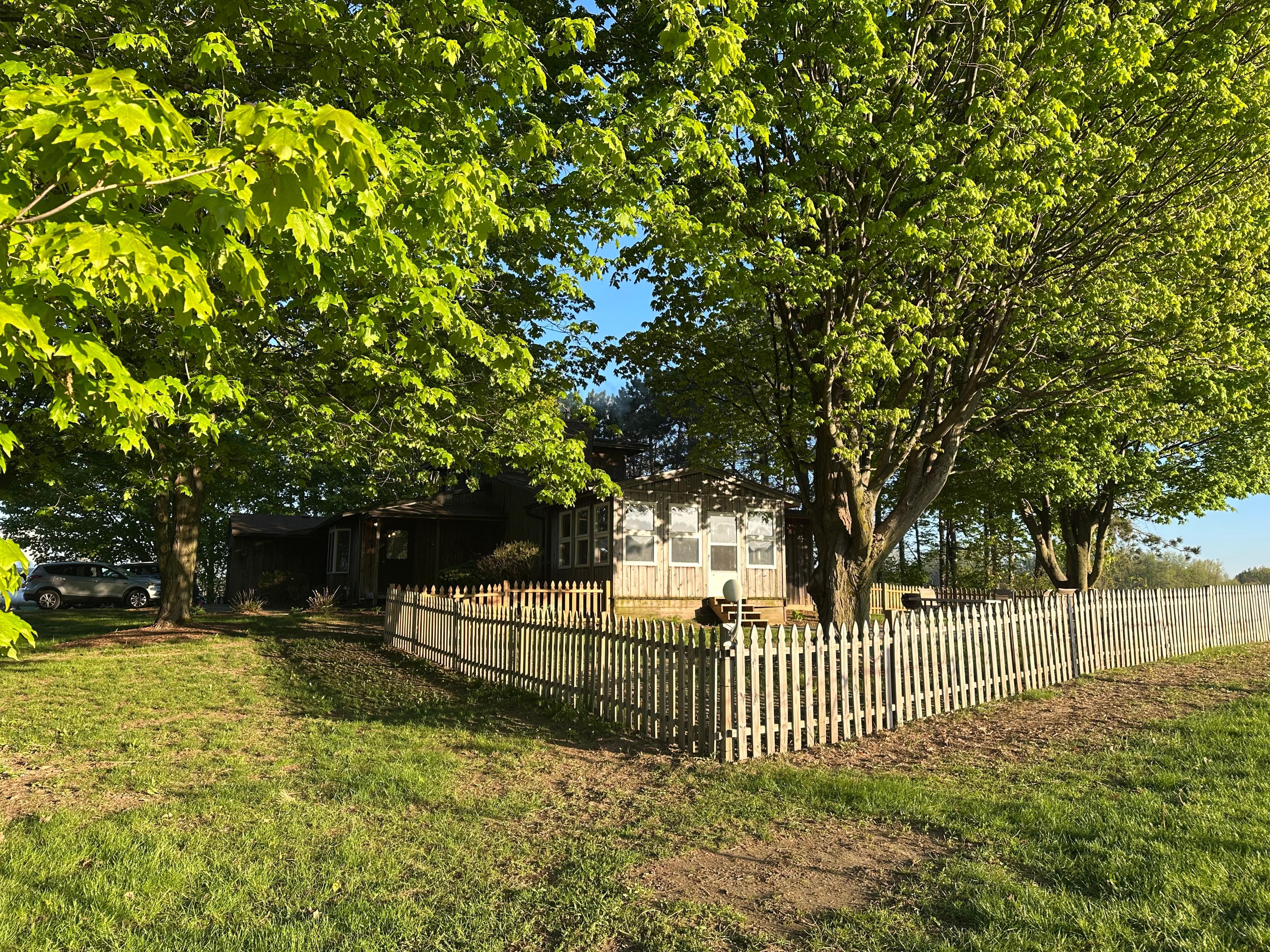 Fenced in back yard with fire pit 