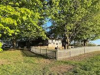 Fenced in back yard with fire pit