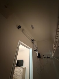 Unsafe wires hanging from ceiling.