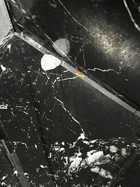 Piece of soap in corner of bathroom floor, there wasn’t even a bar of soap in sight